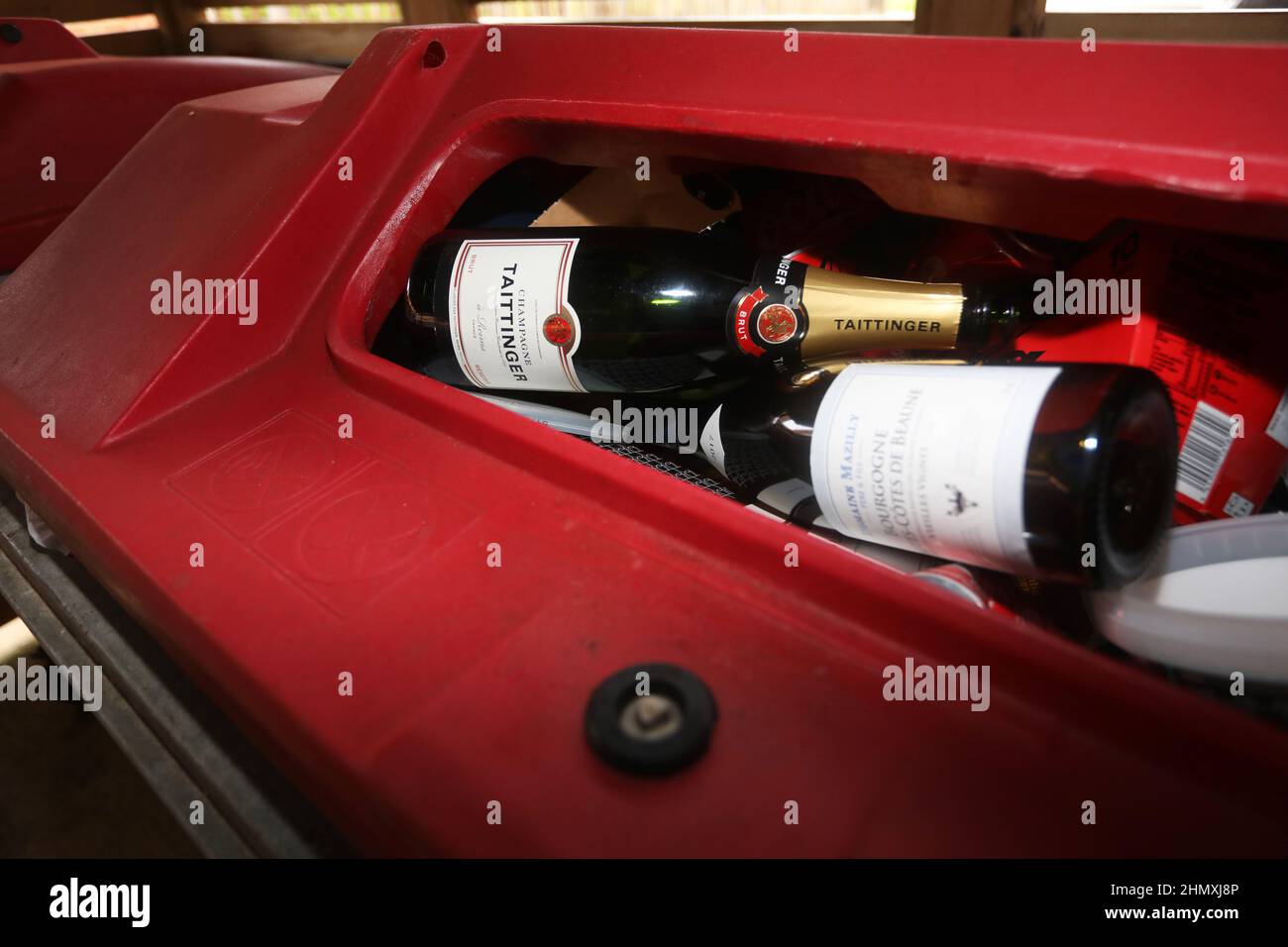 Empty Taittinger Champagne bottles pictured in a recycling bin in Brighton, East Sussex, UK. Stock Photo
