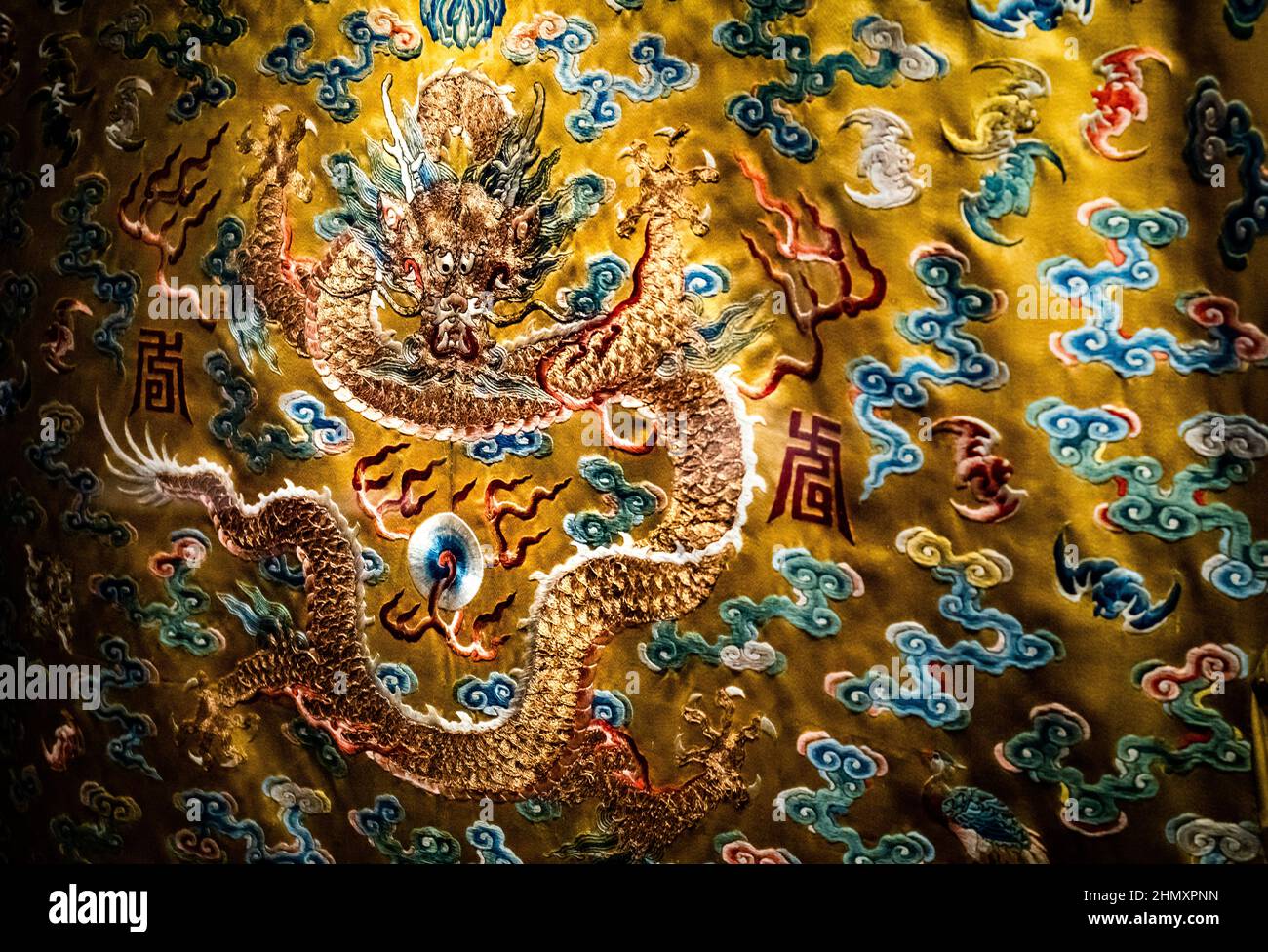 A dragon from an elaborate 19th century embroidered yellow silk dragon