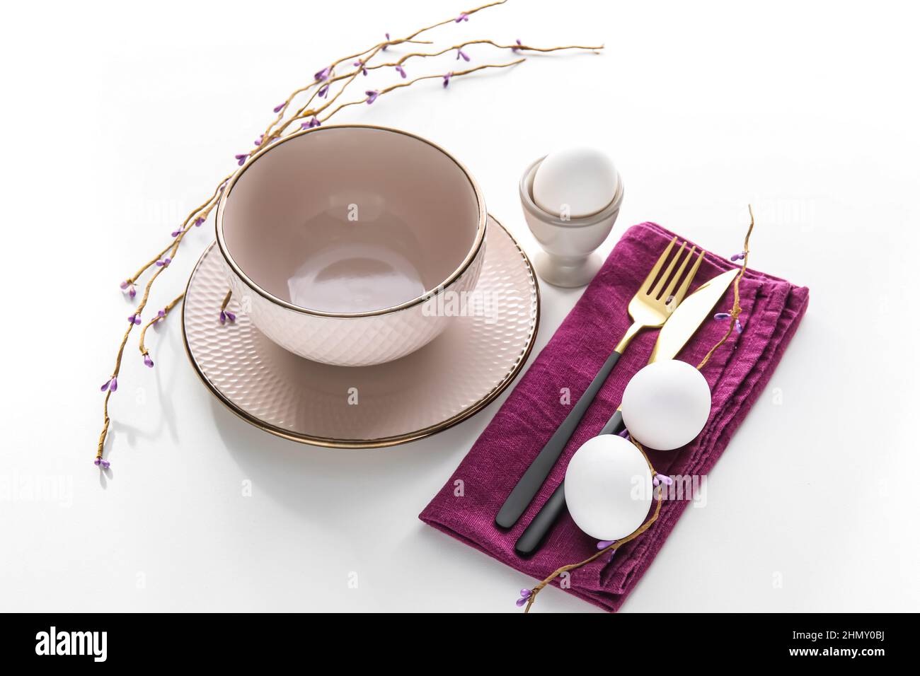 Stylish Easter table setting on white background Stock Photo