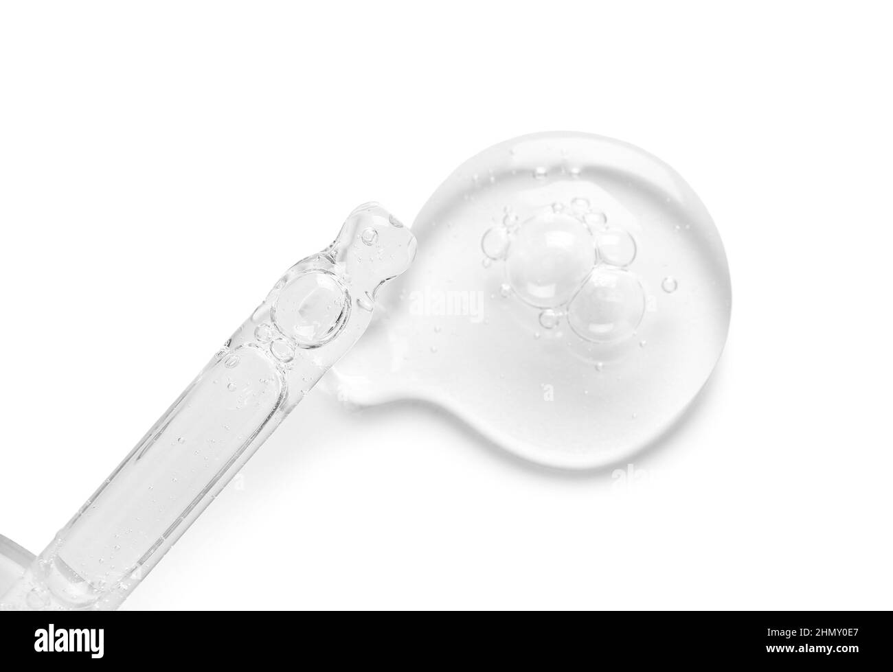 Glass dropper and sample of cosmetic serum on white background Stock Photo