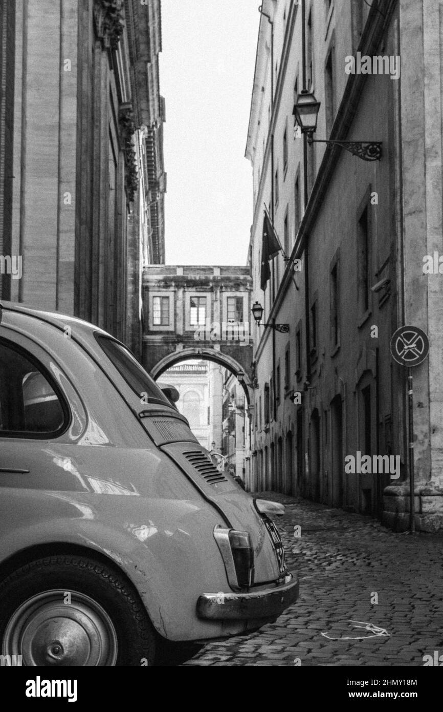 Black and white vertical photo of the back of a classic Italian car, typical Fiat 500 Stock Photo