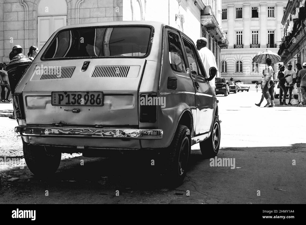 Black and white photo of little car model Fiat 126, a cheap car in the street Stock Photo