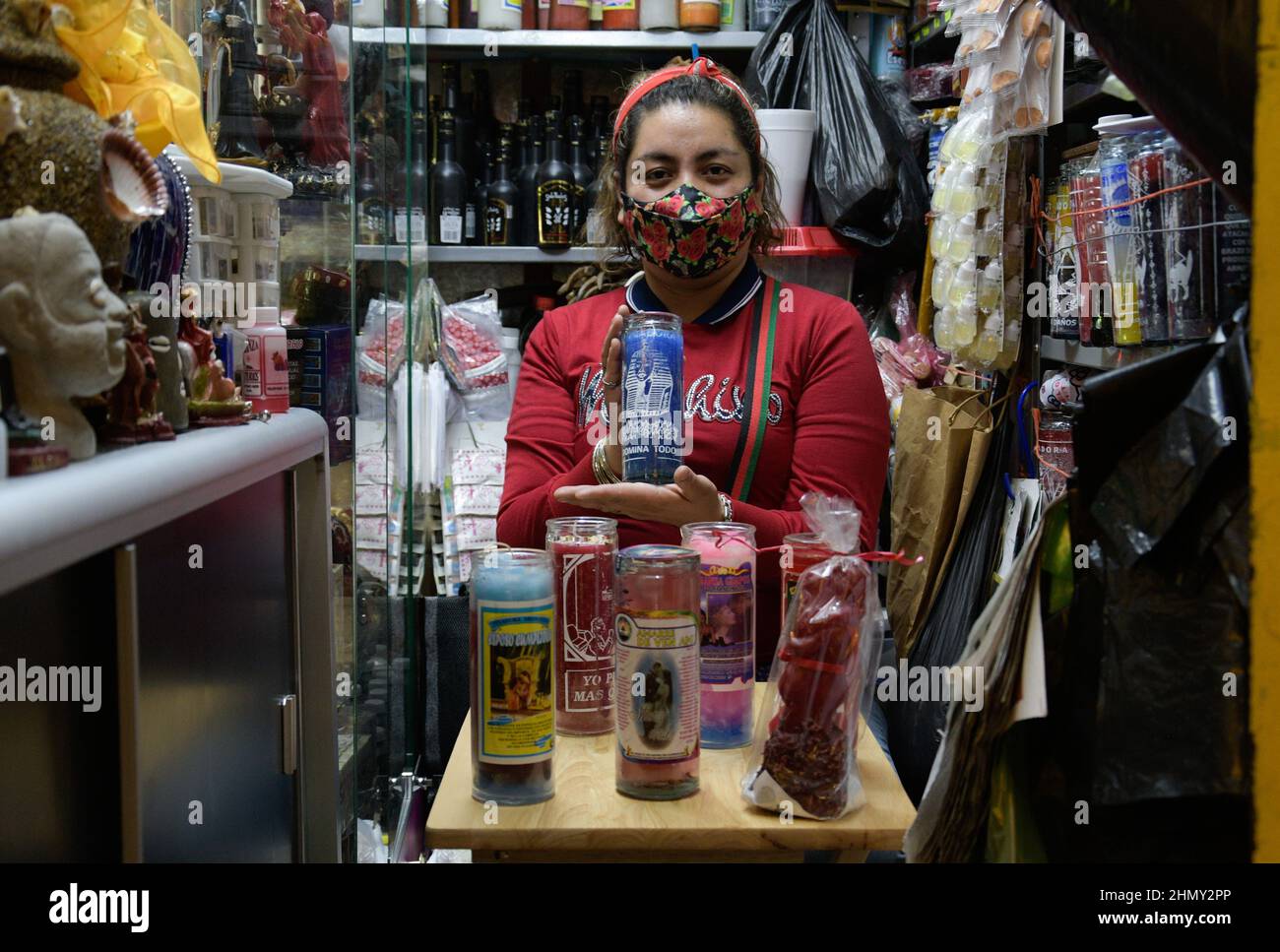 A woman from the Sonora Market offers esoteric products to make love spells for people who want to recover their old partners during the eve of the Va Stock Photo