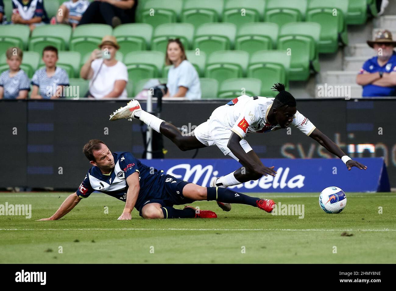 Melbourne, Australia, 12 February, 2022. Valentino Yuel of Newcastle Jets and Leigh Broxham of Melbourne Victory collide during the A-League soccer match between Melbourne Victory and Newcastle Jets at AAMI Park on February 12, 2022 in Melbourne, Australia. Credit: Dave Hewison/Speed Media/Alamy Live News Stock Photo