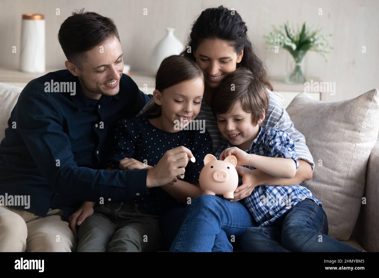 Happy family saving money for future purchase Stock Photo