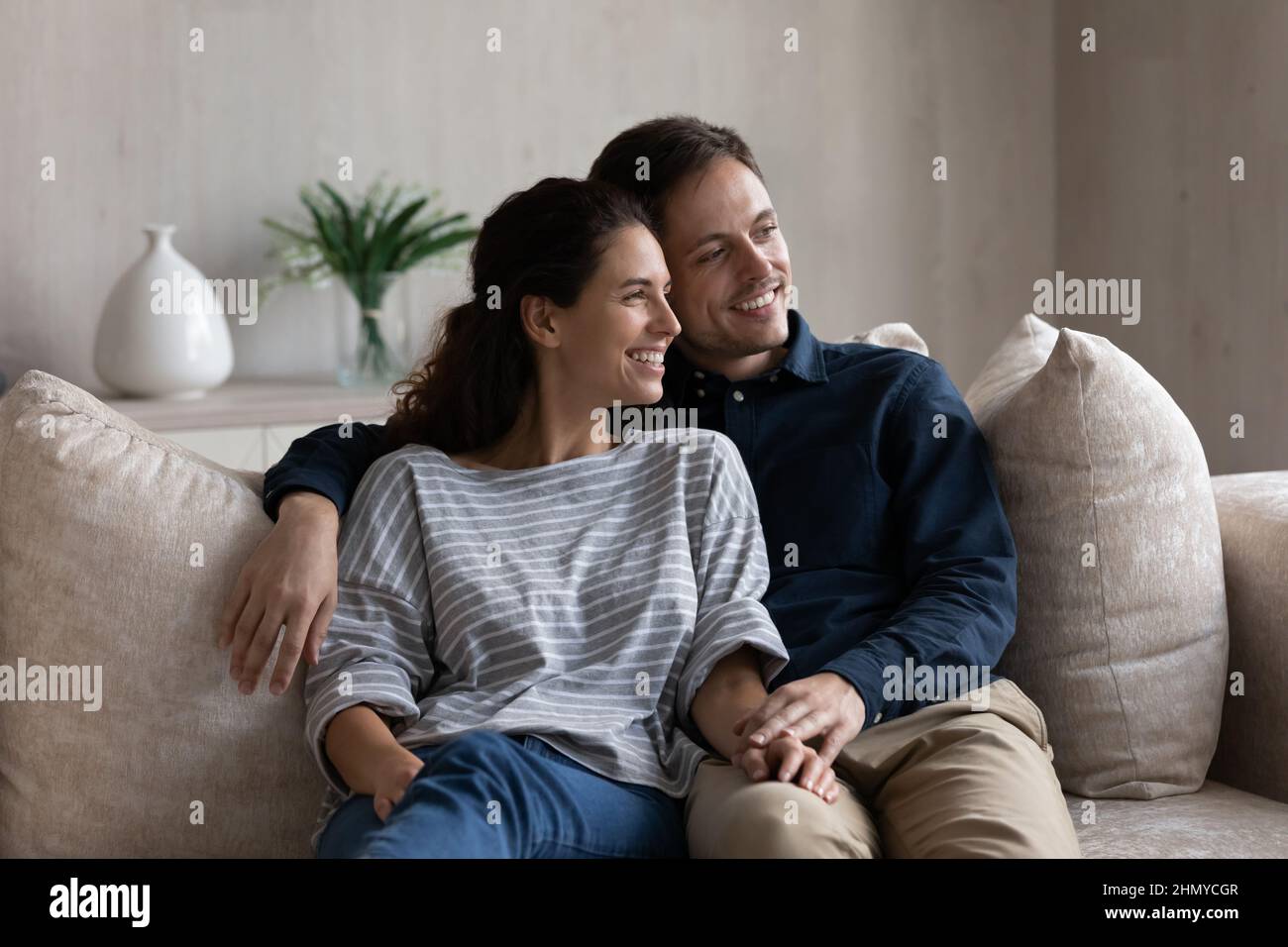 Happy married couple relaxing on couch at home Stock Photo Alamy