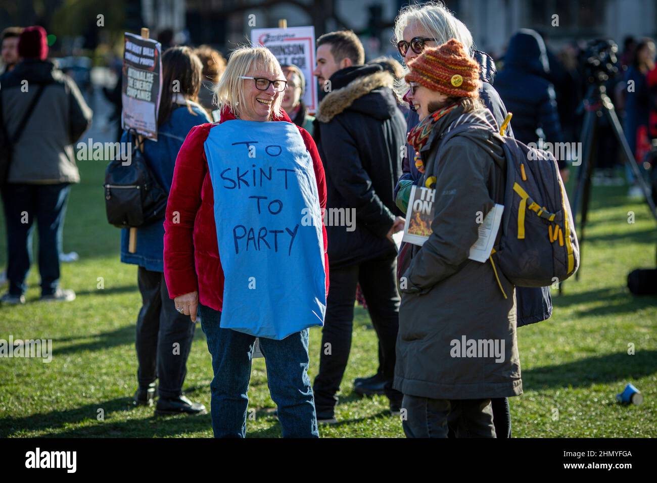London, UK 12 th February 2022. Female wearing t-shirt 'To skint to party ' in protest against the rises in fuel prices and costs. Stock Photo
