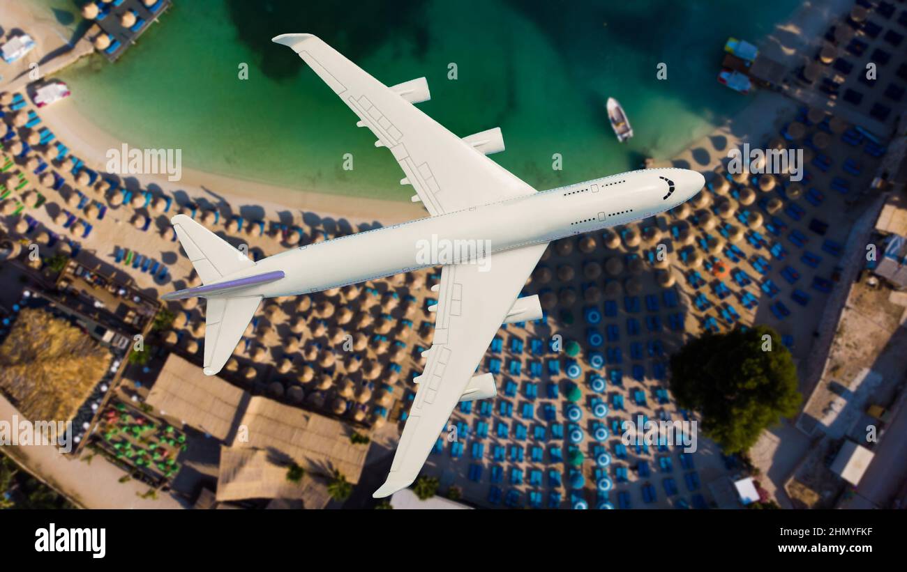 Airplane landing above beautiful beach and sea background Stock Photo