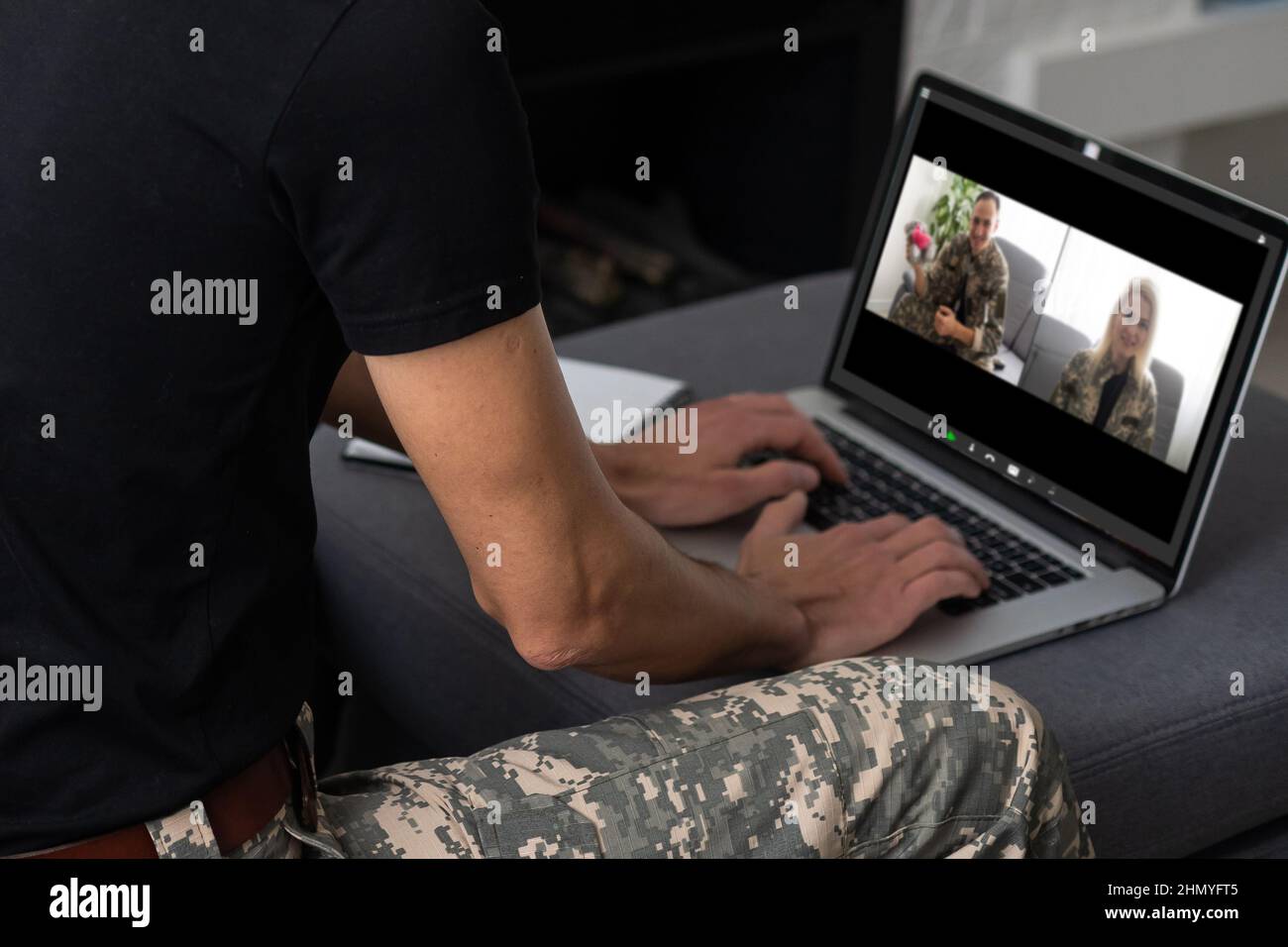 Mature male soldier using laptop in headquarters building for ...
