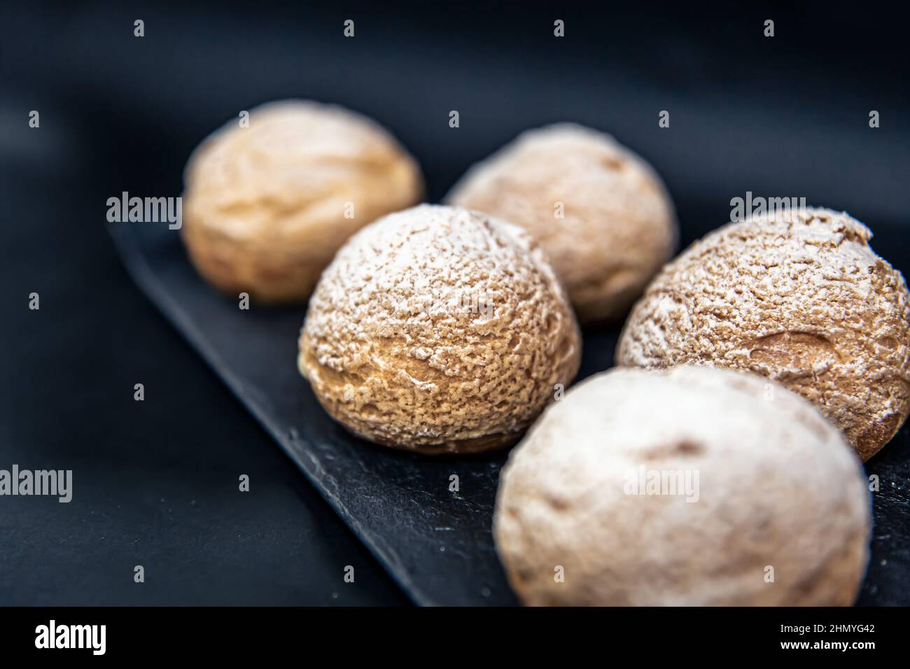 Appetizing Shu cakes on a black background. Stock Photo