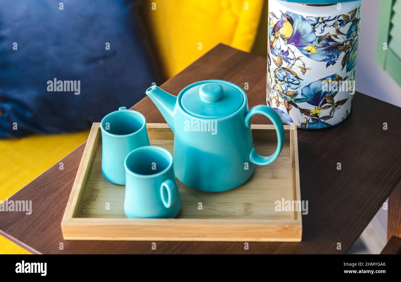 Teapot and two blue cups on the table, top view. Stock Photo