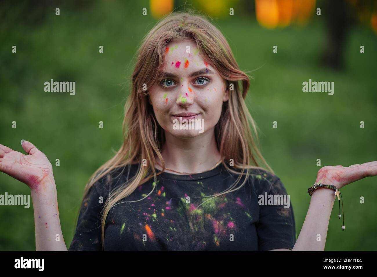Young funny girl posing with colored powder on her face Stock Photo - Alamy