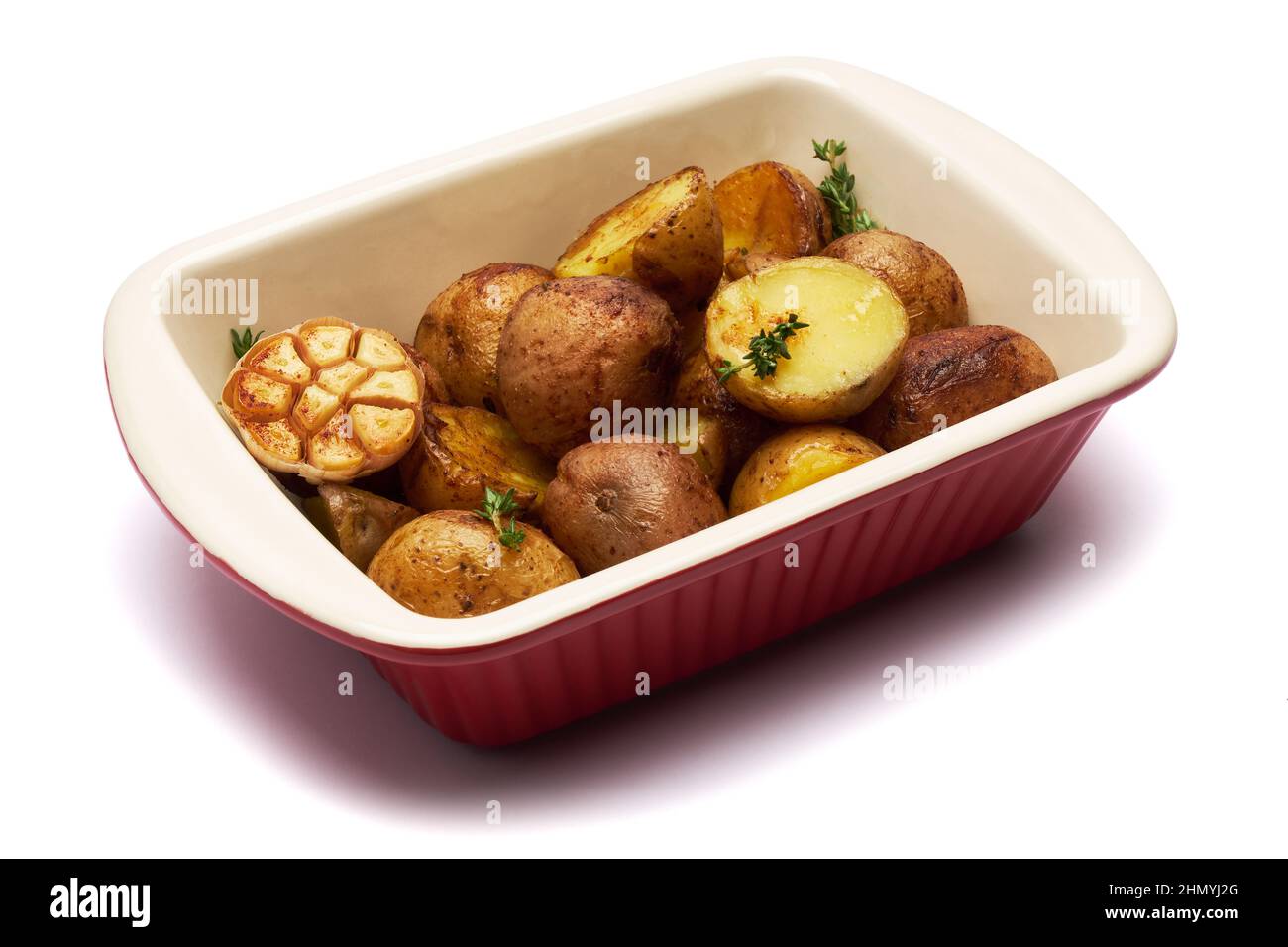 Baked potato in baking dish isolated on white background Stock Photo