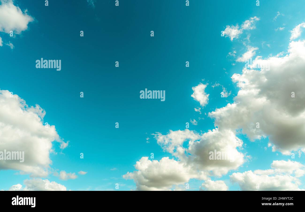 White fluffy clouds on blue sky. Soft touch feeling like cotton. White puffy cloudscape. Beauty in nature. White cumulus clouds background with space Stock Photo