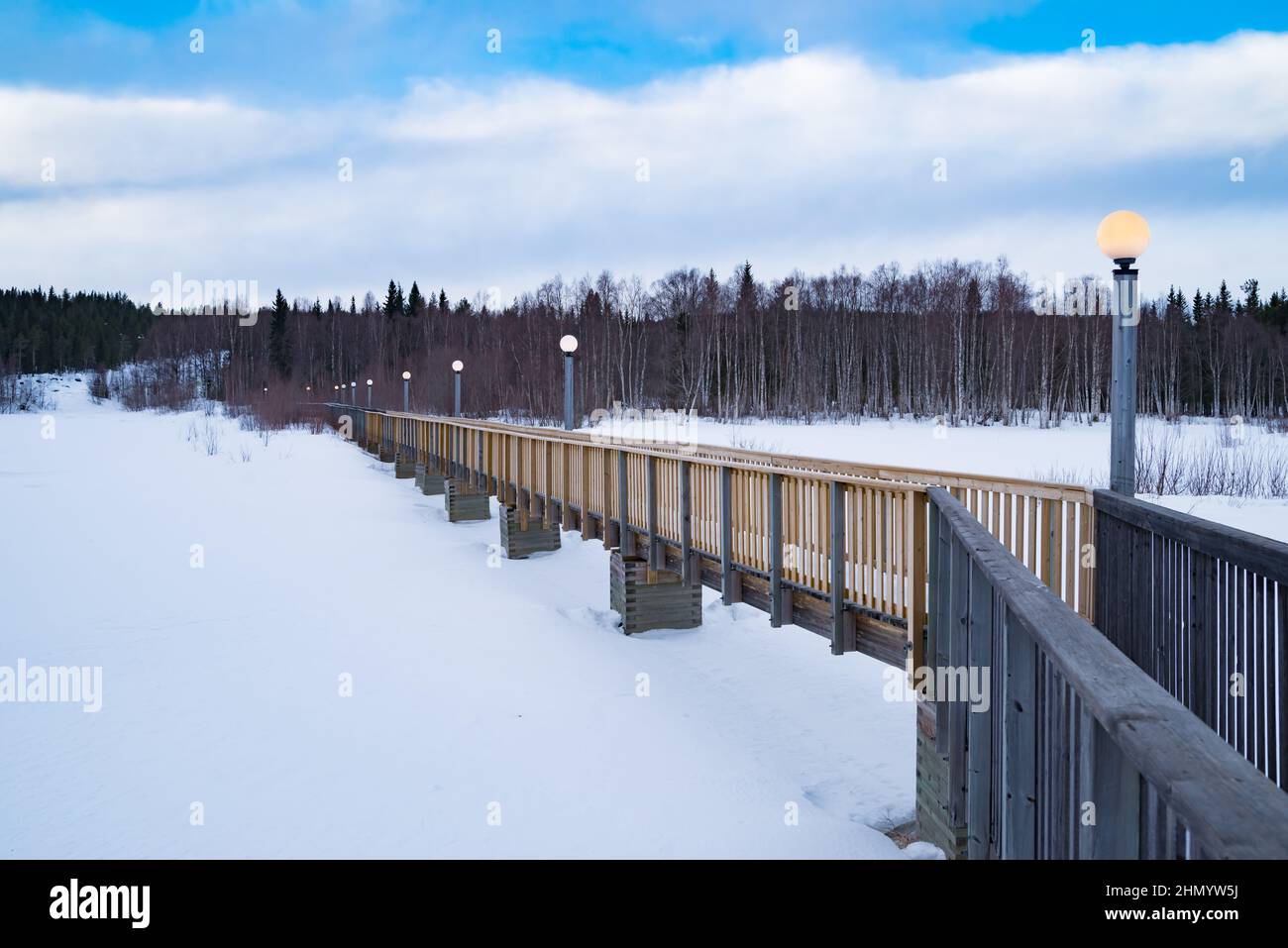 small wooden footbridge across the Pitea river in Sweden. In the background the famous Storforsen rapids Stock Photo