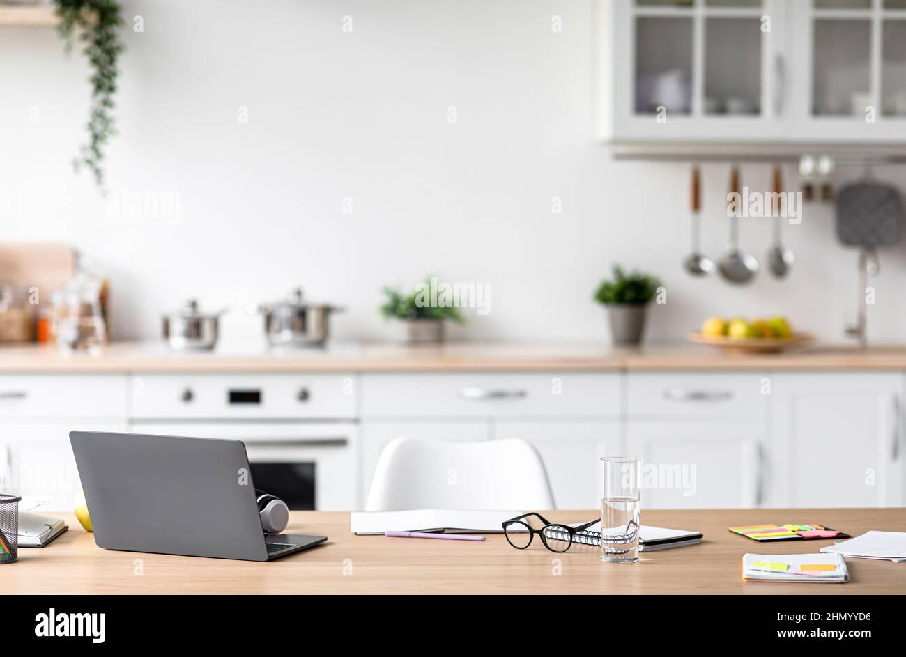 Workplace of student, blogger, manager and businessman, study or work remote in minimalist kitchen interior Stock Photo