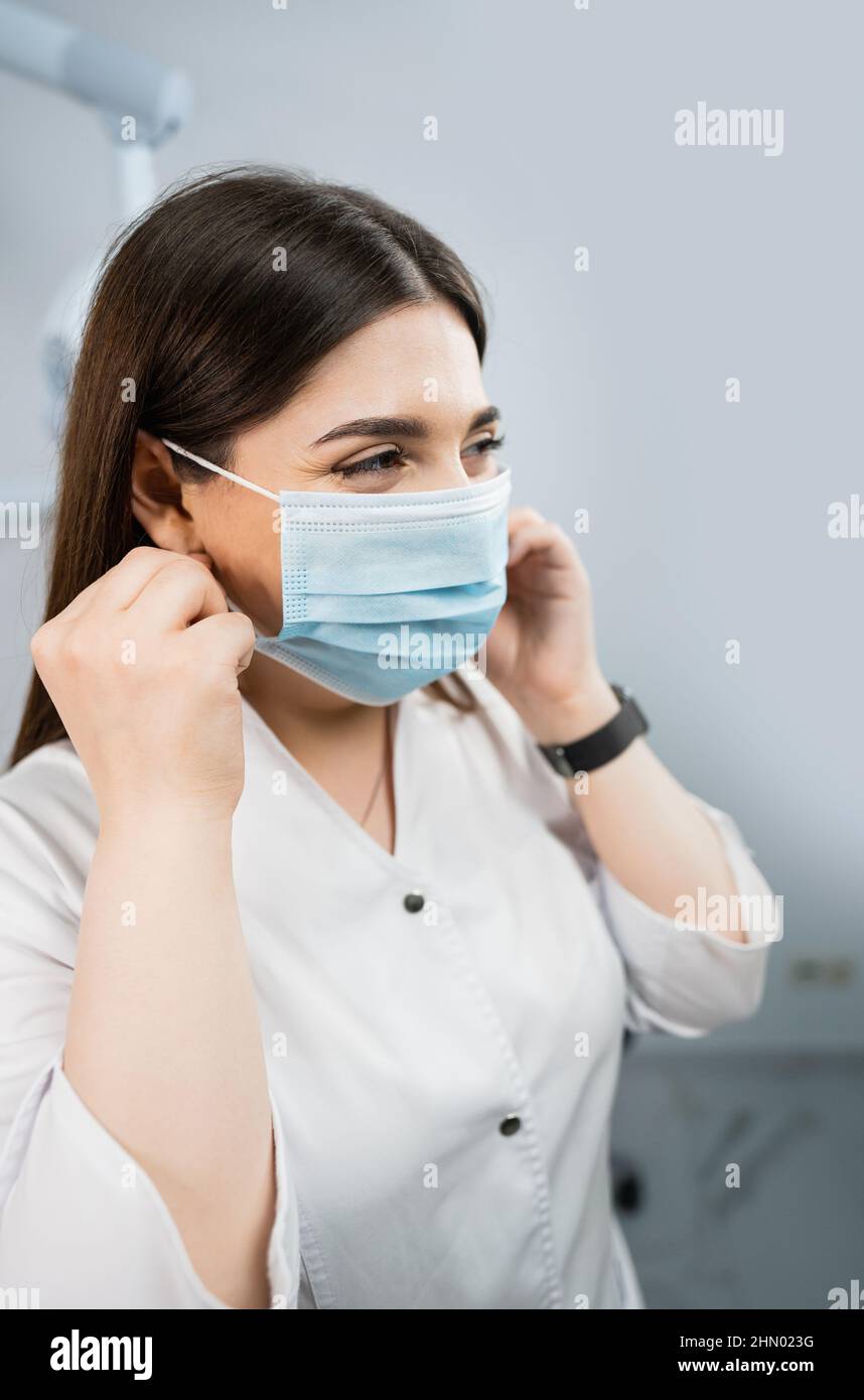 Doctor puts on a medical mask Stock Photo