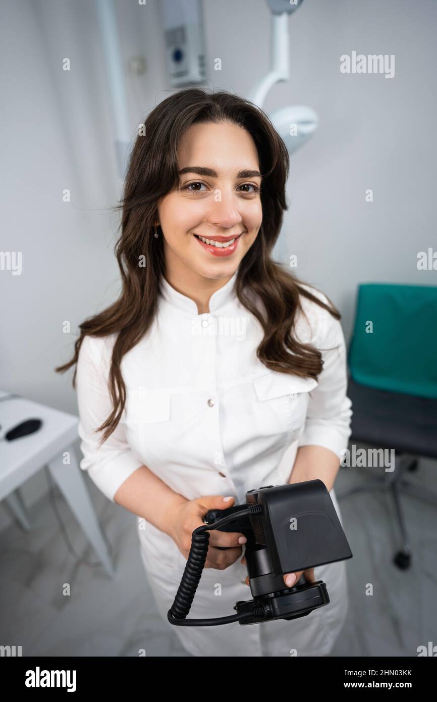 Dentist with photo camera in dental office  Stock Photo