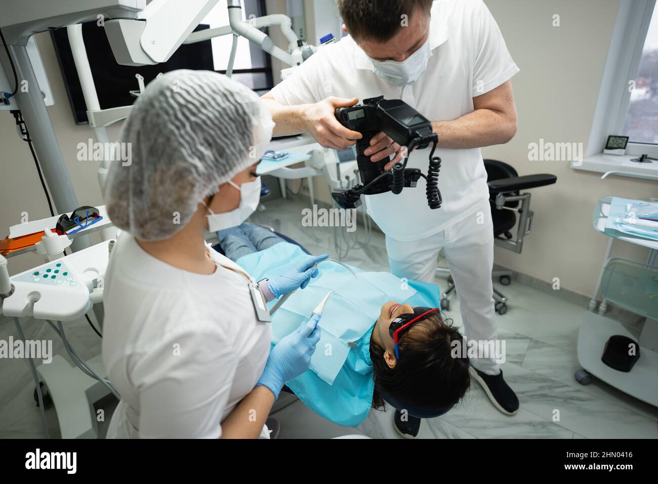 Dentist uses a photo camera to examine a patient  Stock Photo