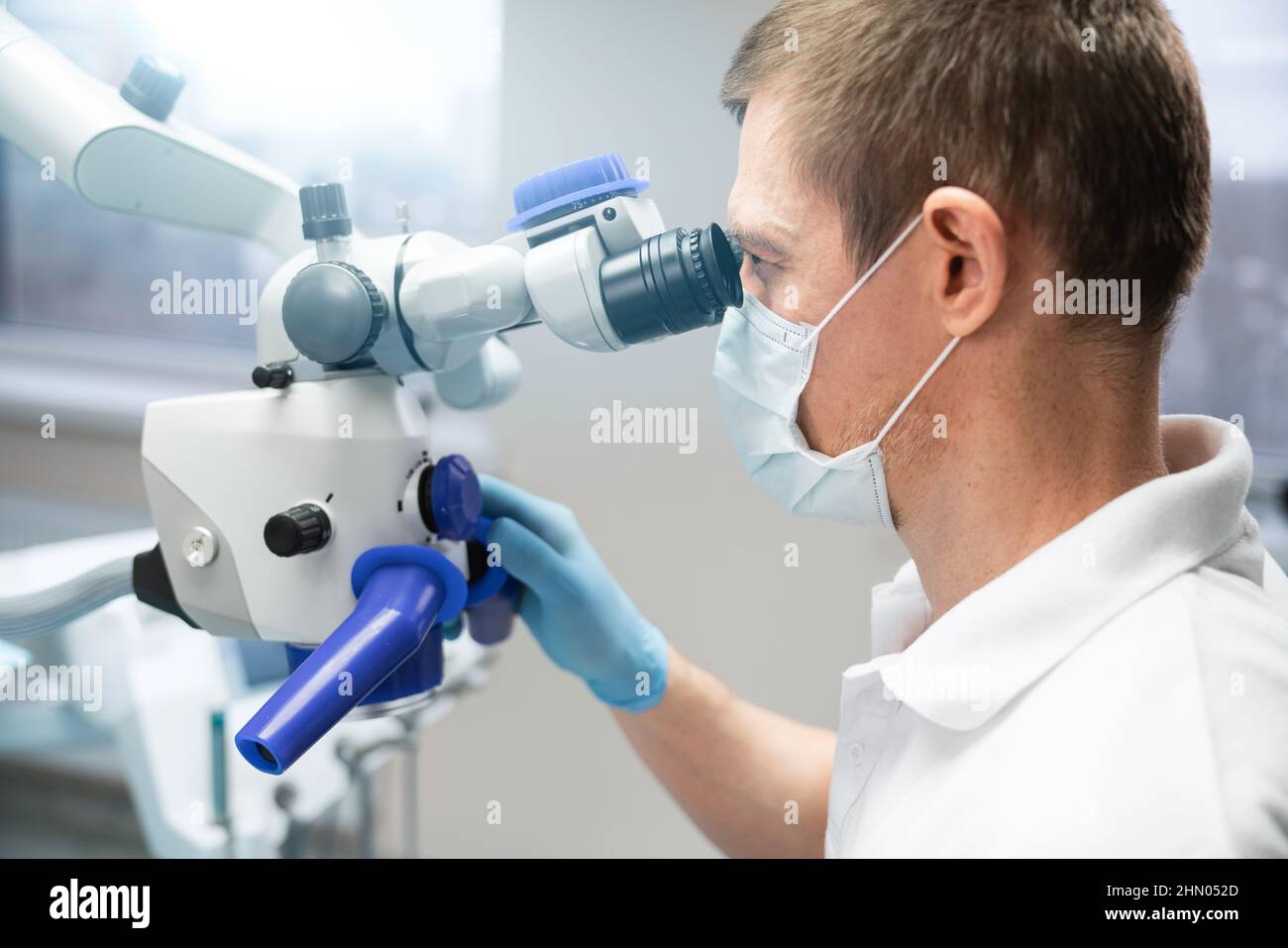 Dentist makes an operation using a dental microscope Stock Photo Alamy