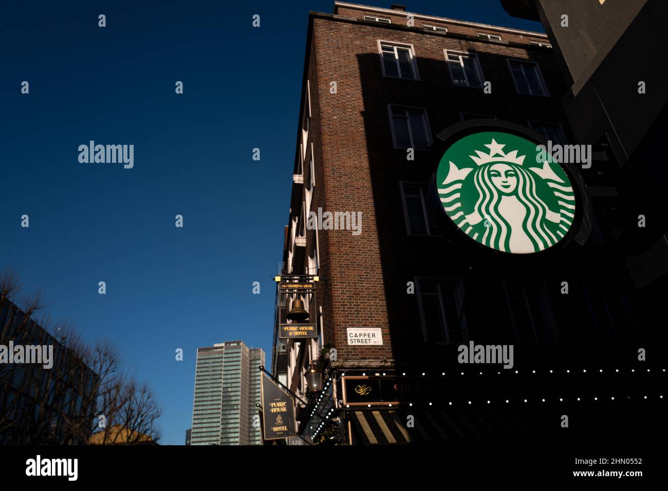 Starbucks logo catching the sunlight on Tottenham Court Road on a cold winters day in London UK Stock Photo