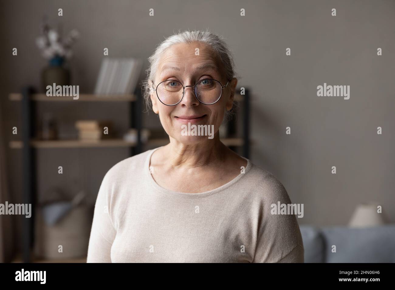 Smiling elderly lady in stylish glasses home head shot portrait Stock Photo