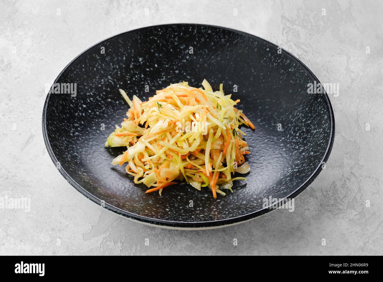 Pickled slices of cabbage and carrot on a plate Stock Photo