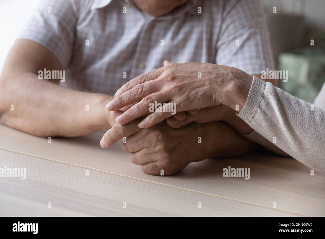Elderly couple holding hands with love and support close up Stock Photo