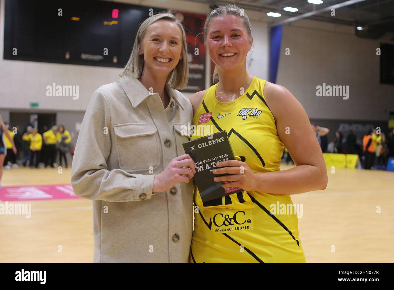 Belle Vue Leisure Centre, Manchester, England, 12/02/22 Vitality Netball Superleague Manchester Thunder vs Surrey Storm Eleanor Cardwell of Manchester Thunder receives the Gilbert Netball player of the match award from former Thunder captain Emma Dovey Credit: Touchlinepics/Alamy Live News Stock Photo