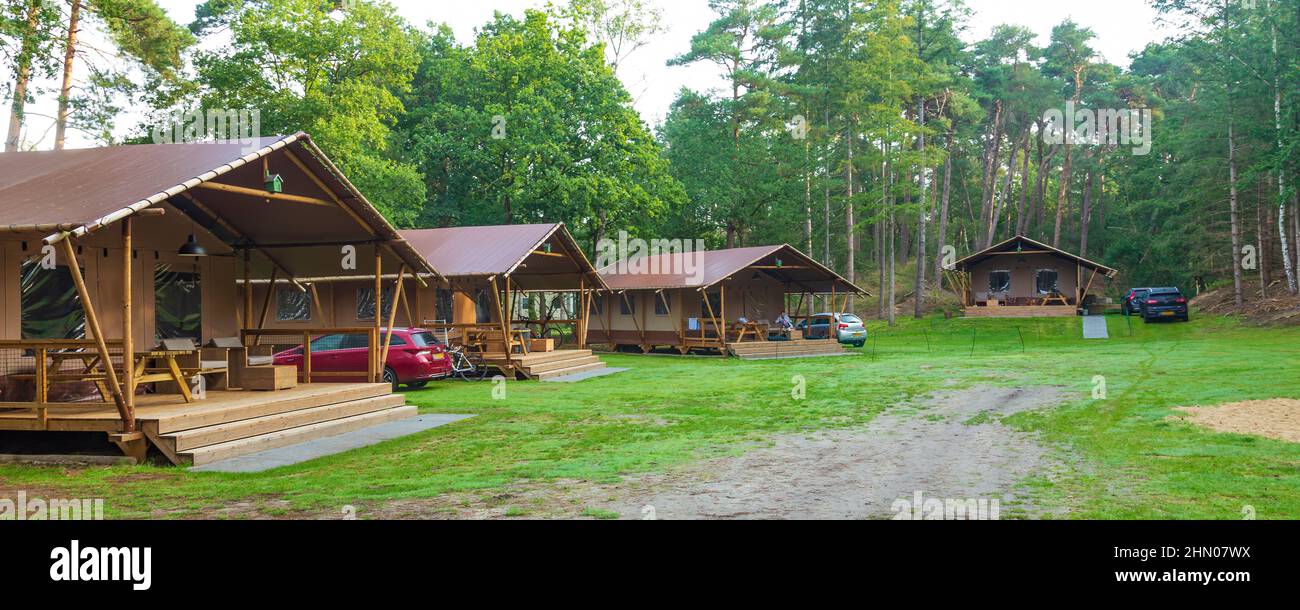 Glamping at a campsite. Luxury tent lodges with all kinds of services for glamorous stay outdoors Stock Photo