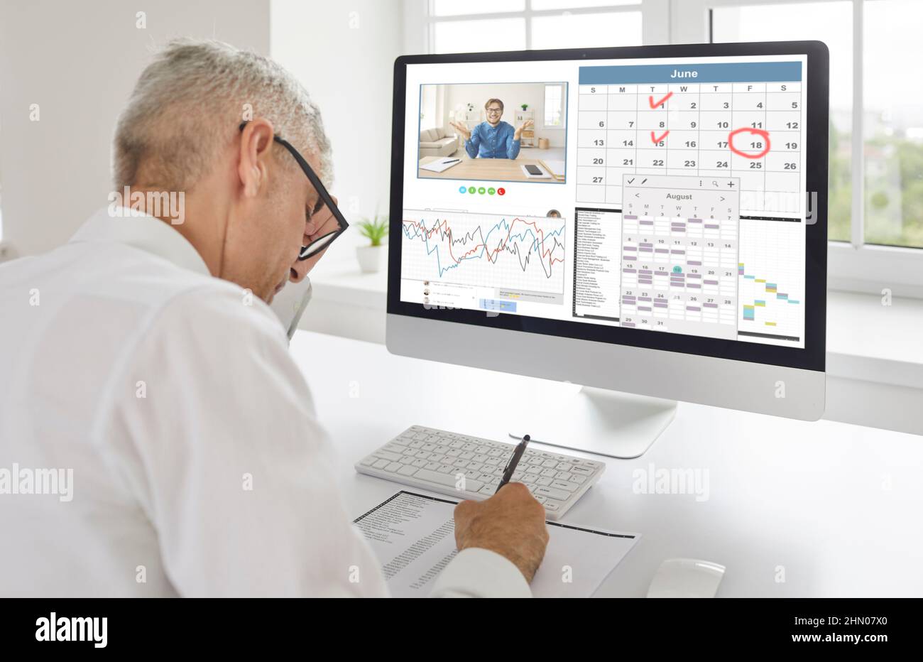 Manager planning working schedule and using business calendar app on his computer Stock Photo