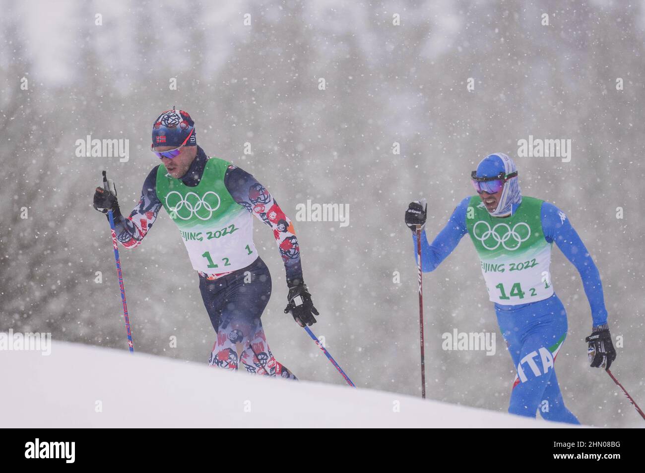 Zhangjiakou, China's Hebei Province. 13th Feb, 2022. Paal Golberg (L) of Norway competes during the cross-country skiing men's 4x10 km relay of the Beijing Winter Olympics at National Cross-Country Skiing Centre in Zhangjiakou, north China's Hebei Province, Feb. 13, 2022. Credit: Hu Huhu/Xinhua/Alamy Live News Stock Photo