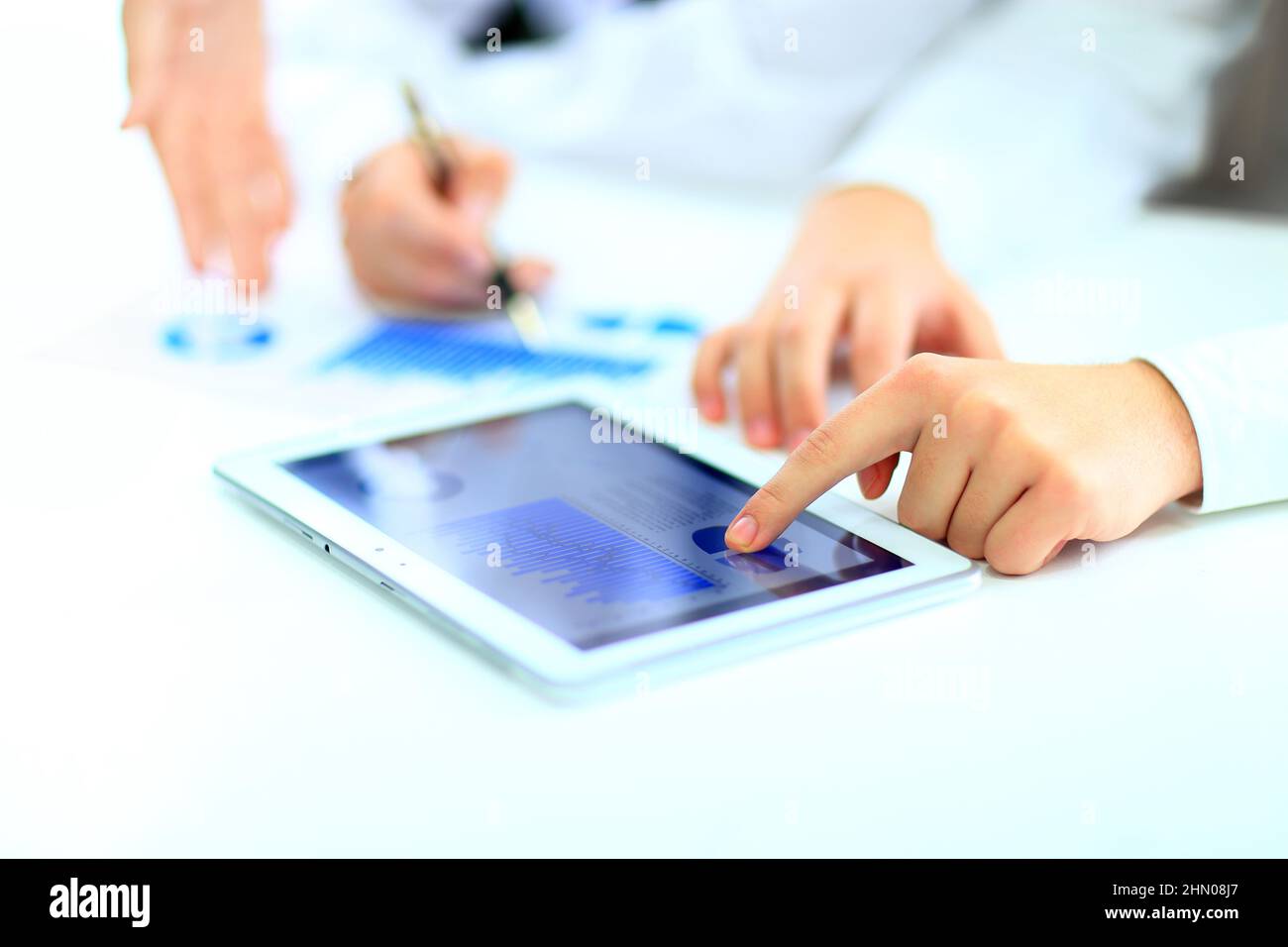 Image of human hand pointing at touchscreen with business document ...