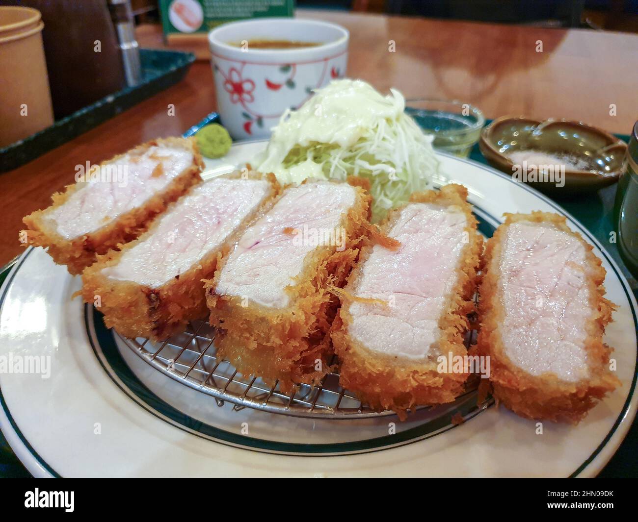 Tonkatsu, a Japanese breaded, deepfried pork cutlet. Served with cabbage salad and wasabi Stock