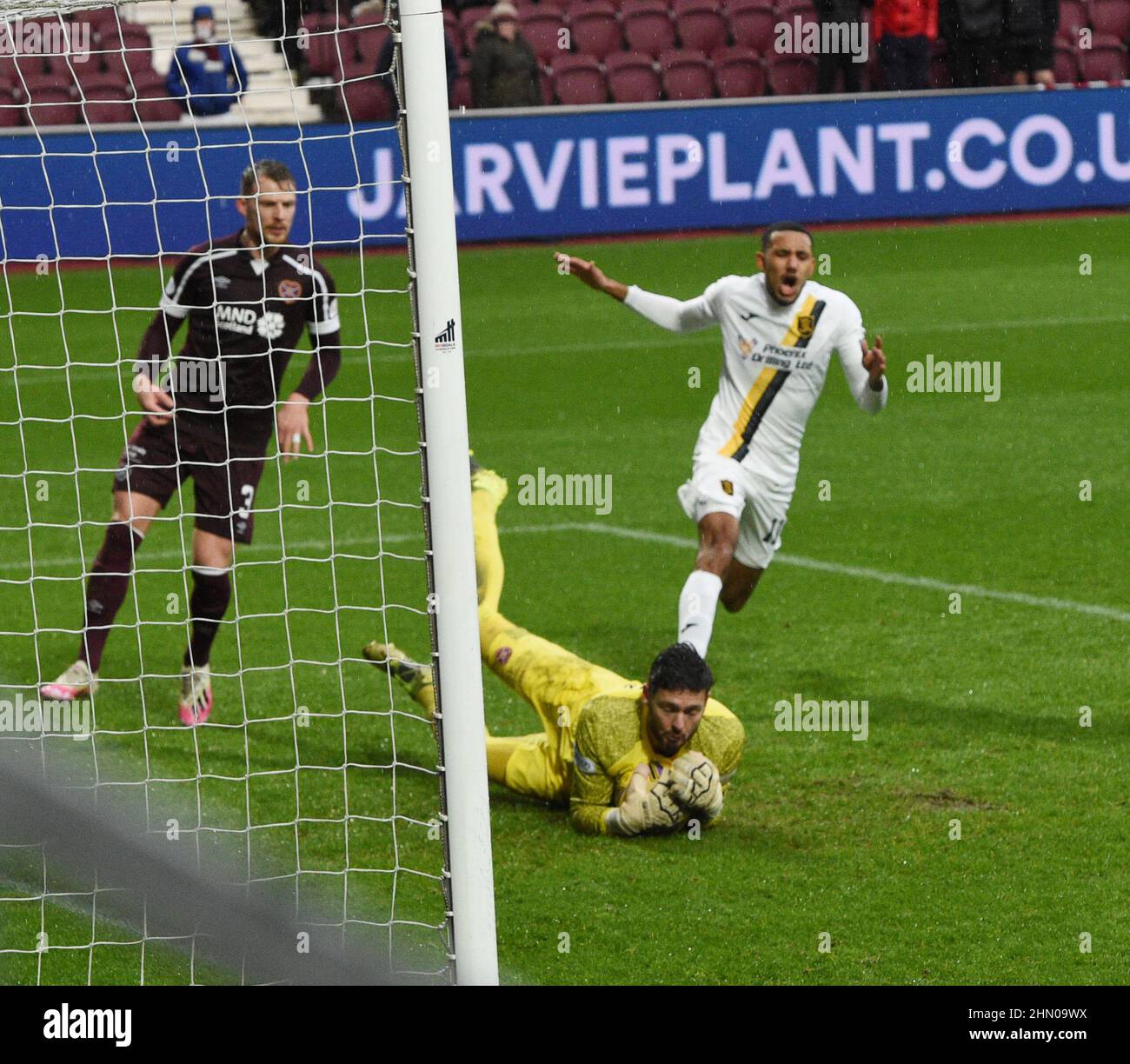 Tynecastle Park Edinburgh.Scotland UK.12TH Feb 22 Heart of Midlothian vs Livingston Scottish Cup Tie. Livingston's Scott Pittman had gone closest to breaking the deadlock in 90 minutes when the midfielder's deflected shot hit a post and rebounded into the arms of Hearts' goalkeeper Craig Gordon looking on Hearts' Stephen Kingsley & Livingston's Cristian Montano Credit: eric mccowat/Alamy Live News Stock Photo