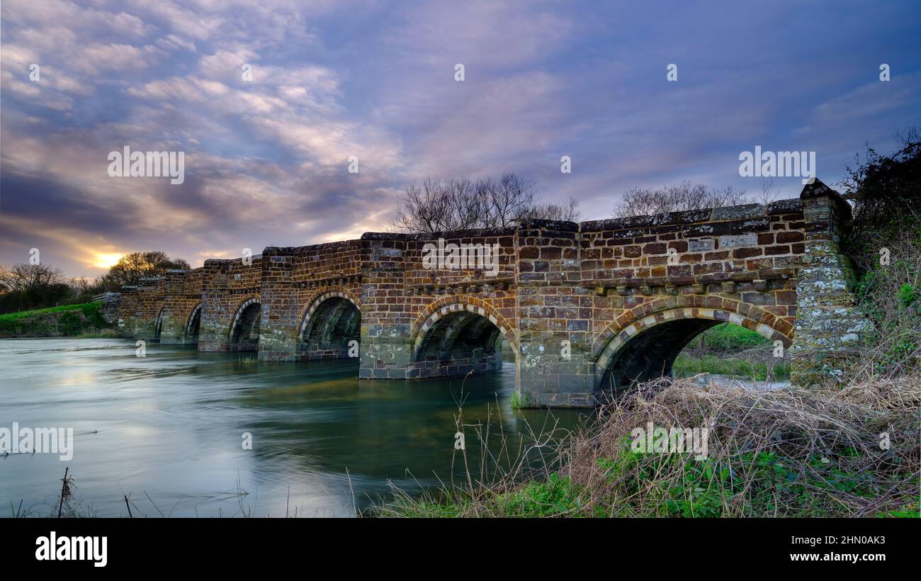 Sturminster Marshall, UK - March 21, 2020:  Spring sunset on the River Stour at the White Mill Bridge near Sturminster Marshall, Dorset, UK Stock Photo