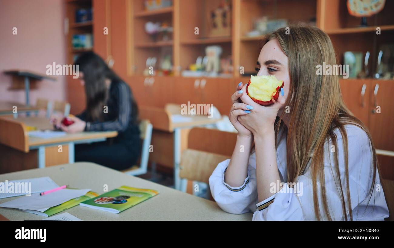 Girl eat apples in class during recess Stock Photo Alamy