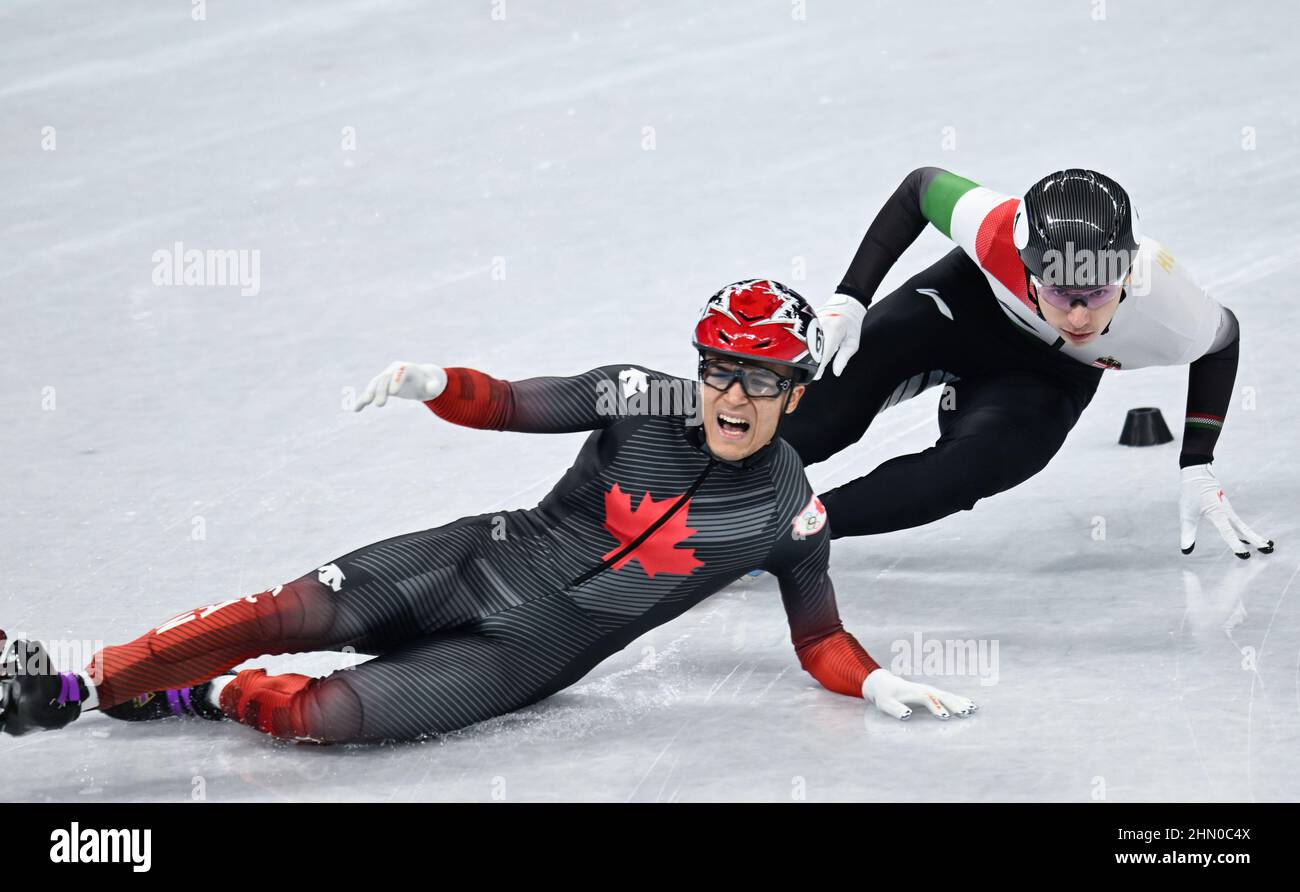 Beijing, China. 13th Feb, 2022. Jordan Pierre-Gilles (L) of Canada and  Shaoang Liu of Hungary compete during the men's 500m short track speed  skating quarterfinal at Capital Indoor Stadium in Beijing, capital