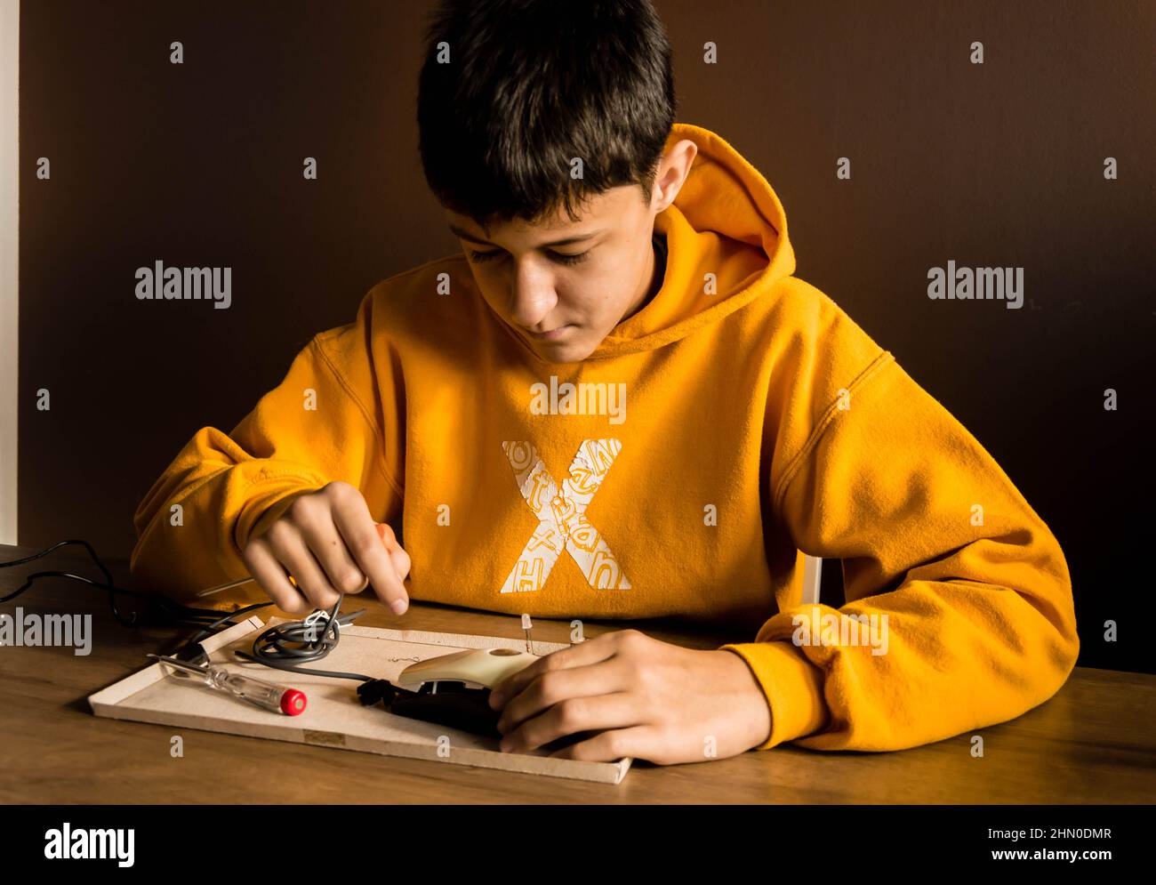 A boy repairing with tools and learning Stock Photo