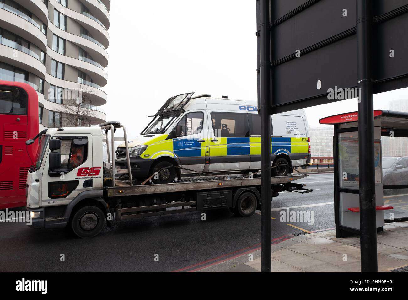 A Met Police van on the back of a breakdown truck. Image taken on Vauxhall Bridge, London UK Stock Photo