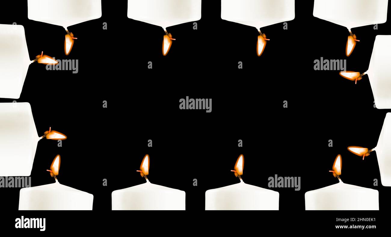 Burning white candles on a black background or in the dark, a place for