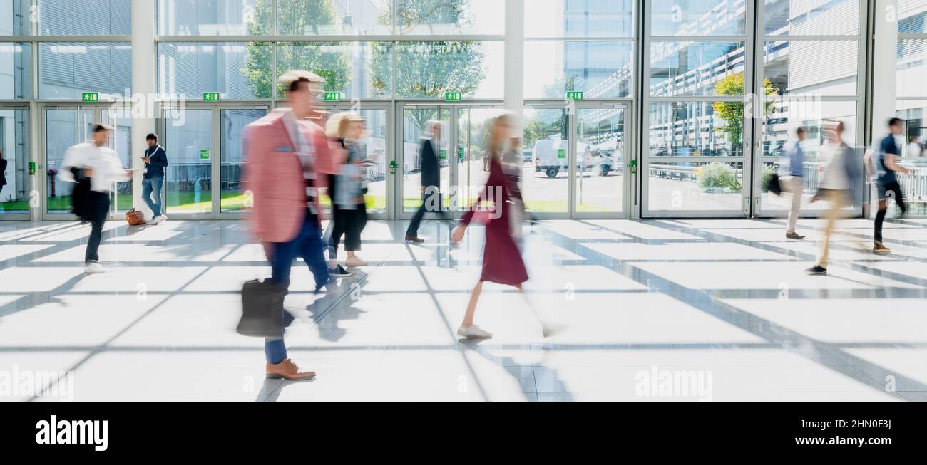 Few anonymous people go and wait in Halle Stock Photo