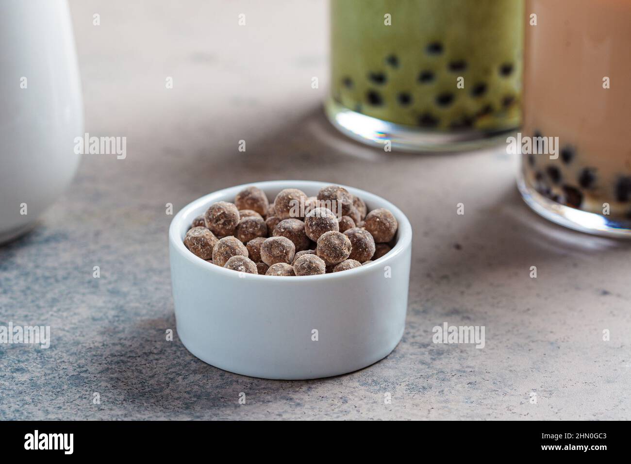 Dry tapioca pearls in a white bowl for cooking bubble tea Stock Photo