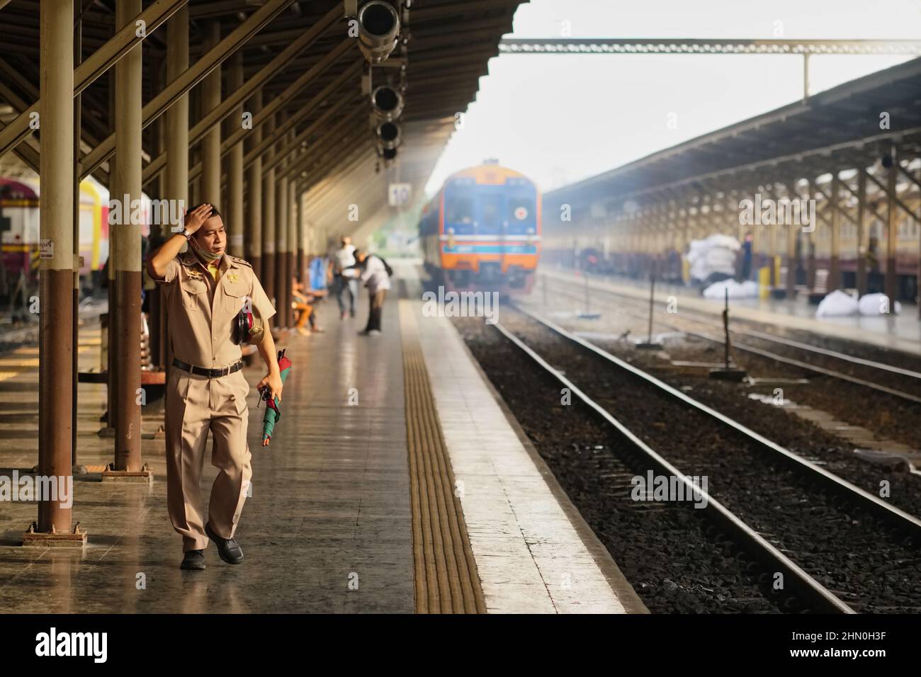 The station master at Hualamphong (Hua Lamphong) Station in Bangkok, Thailand, just having overseen the departure of a train Stock Photo