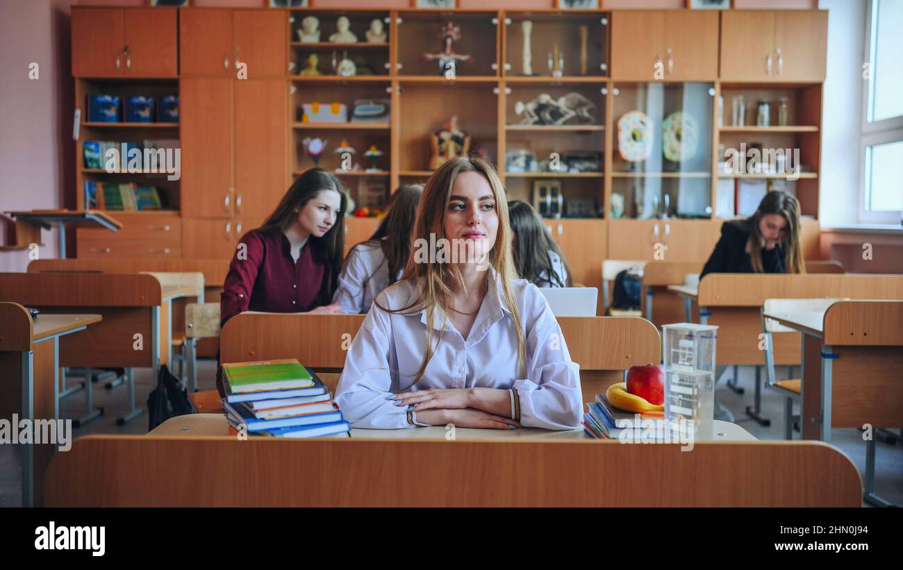 A girl student sitting at a desk in the classroom Stock Photo - Alamy