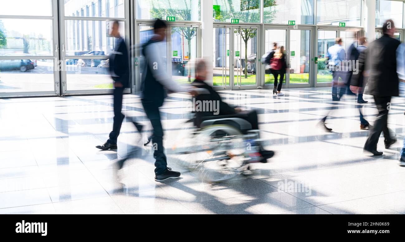 Person in a wheelchair in crowd as an inclusion concept image Stock