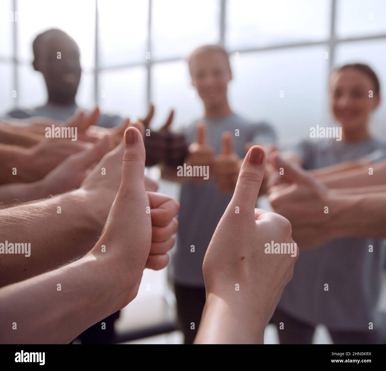 close up. group of young people showing thumbs up Stock Photo - Alamy