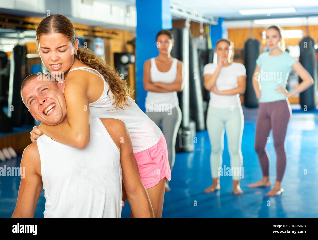 Girl practicing guillotine choke on opponent in sparring with man Stock Photo Alamy