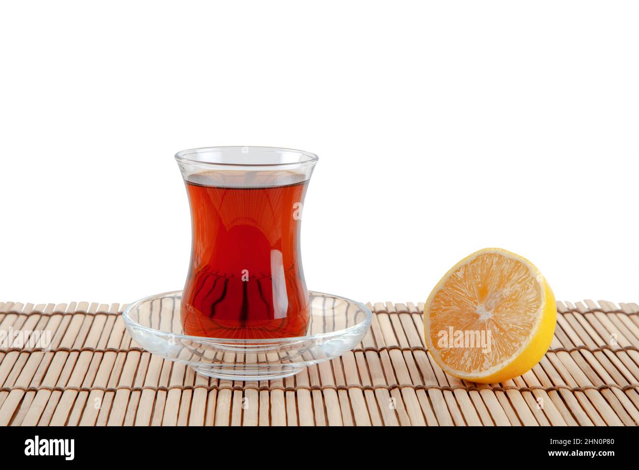Glass of turkish tea and lemon on white background Stock Photo