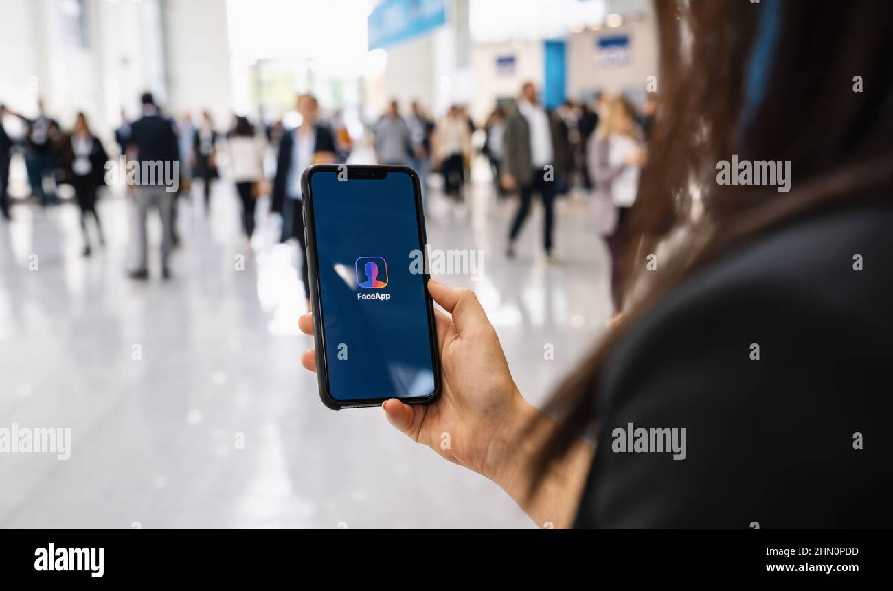 Hand Holding Iphone Xs with FaceApp on the screen, faceapp is a popular ...
